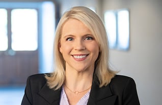 Headshot of Amanda Eldridge of Commerce Trust Company in Dallas, Texas wearing a pink shirt, necklace, and a black blazer