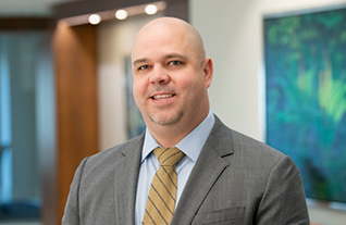 Headshot of Commerce Trust's Jeremy Taylor in an office setting wearing a suit and tie